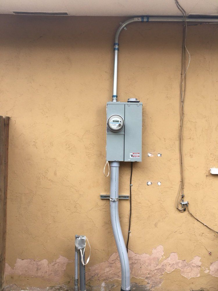There is a meter on the side of a building.