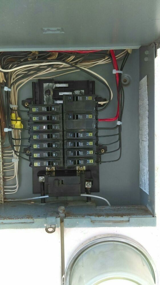 A close up of a electrical box with a lot of wires coming out of it.