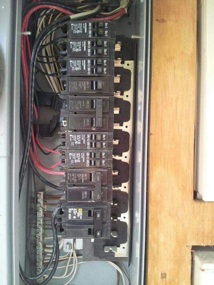 A close up of a electrical box with a bunch of wires coming out of it.