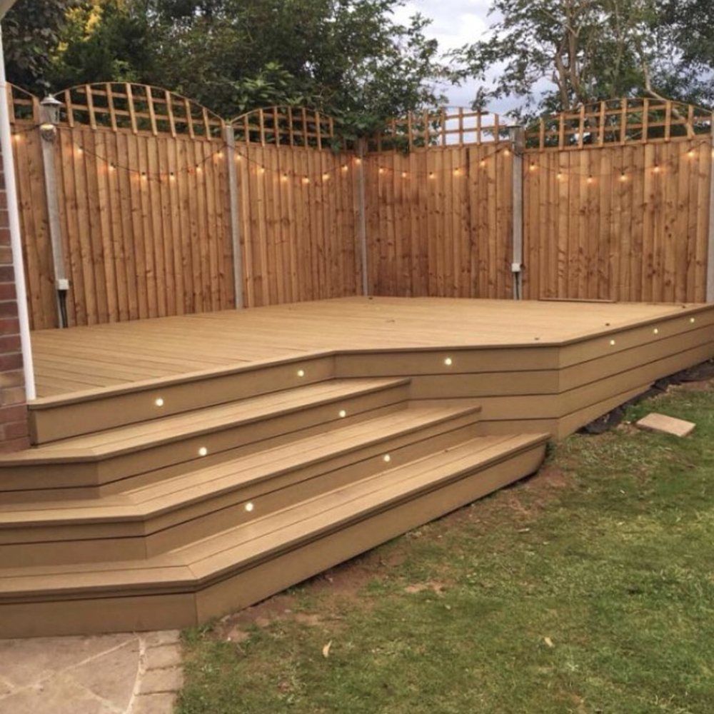 A wooden deck with stairs and a wooden fence