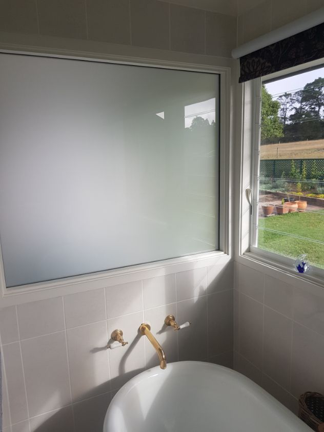 A Bathroom With a Bathtub and a Window — Moss Vale Glass In Moss Vale, NSW