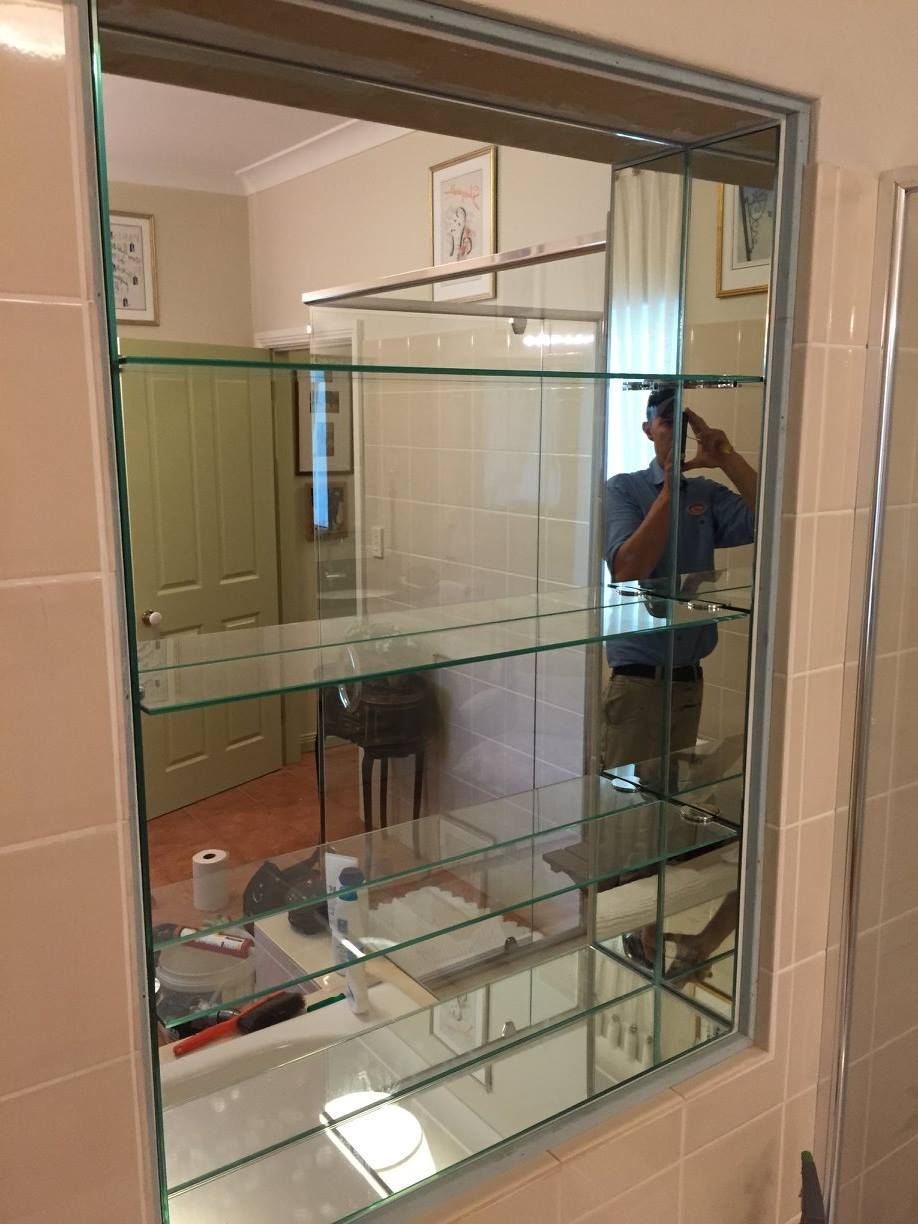 A Man is Taking a Picture of Himself in a Bathroom Mirror — Moss Vale Glass In Bundanoon, NSW
