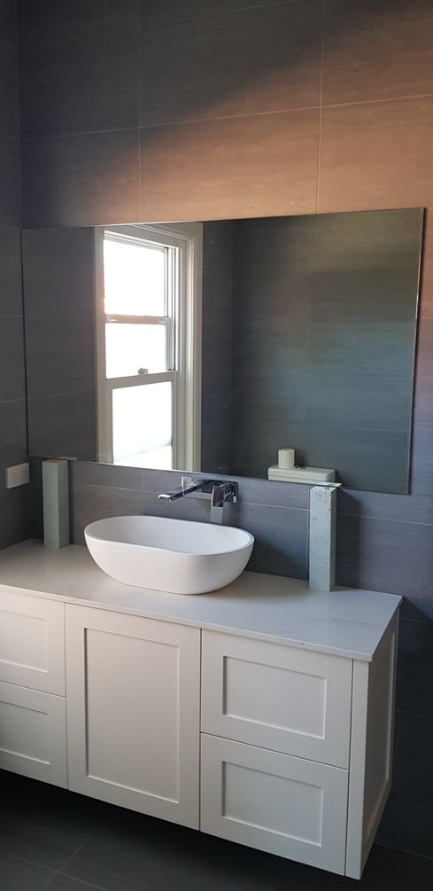 A Bathroom With a Sink and a Large Mirror — Moss Vale Glass In Mittagong, NSW