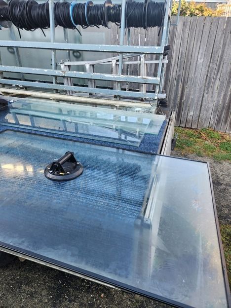 A Large Piece of Glass is Sitting on Top of a Metal Shelf — Moss Vale Glass In Moss Vale, NSW