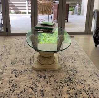 A Glass Coffee Table is Sitting on Top of a Rug in a Living Room — Moss Vale Glass In Moss Vale, NSW