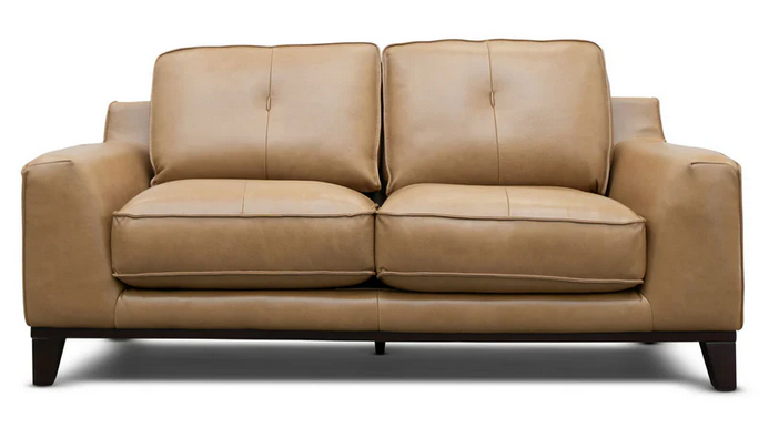 A brown leather couch with wooden legs on a white background.