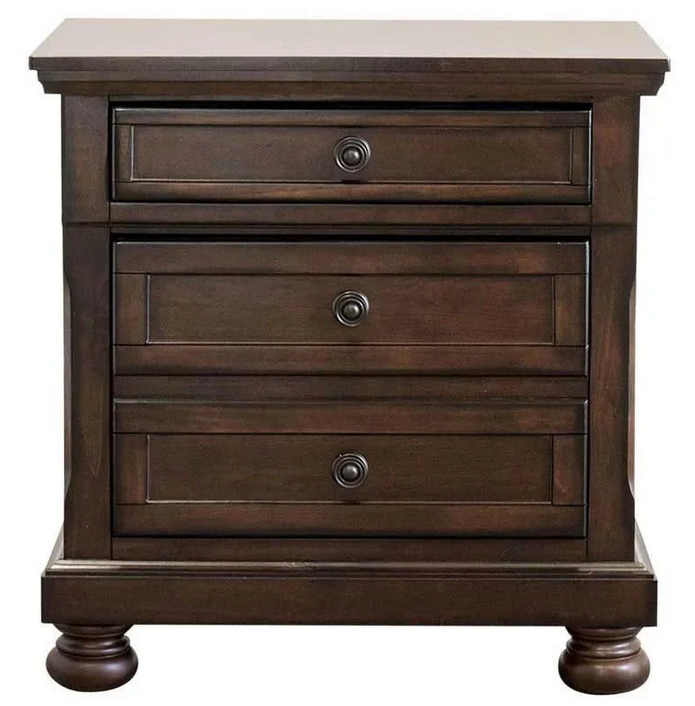 A wooden nightstand with three drawers on a white background