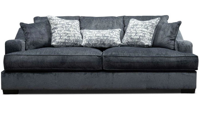 A black couch with white pillows on it on a white background.