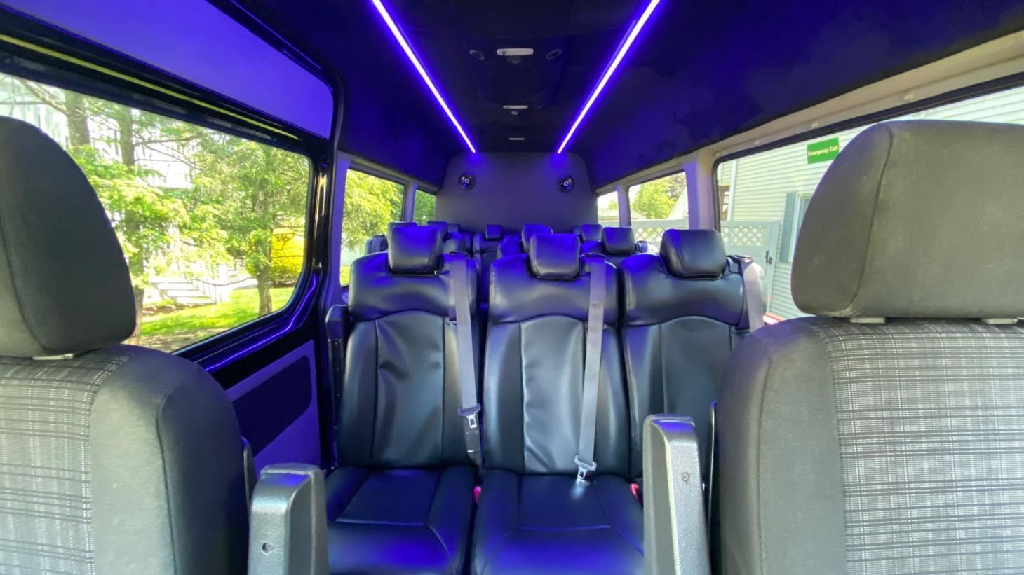 The inside of a van with blue lights on the ceiling.
