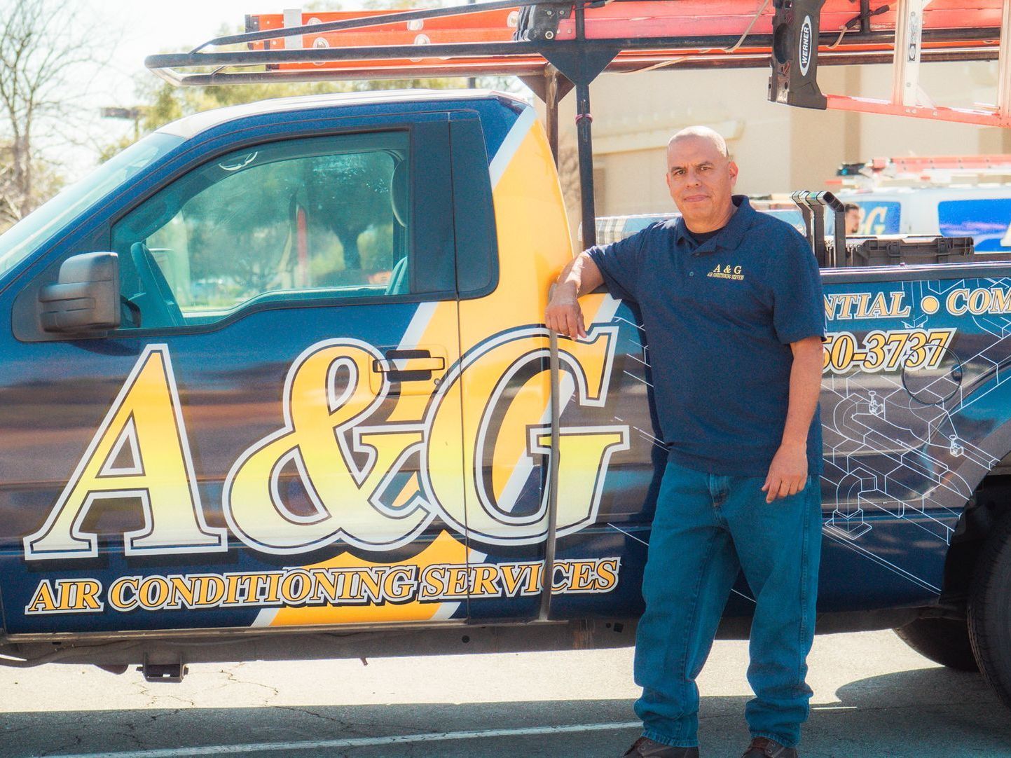A&G Air Solutions Technician standing in front of work truck. Adrian
