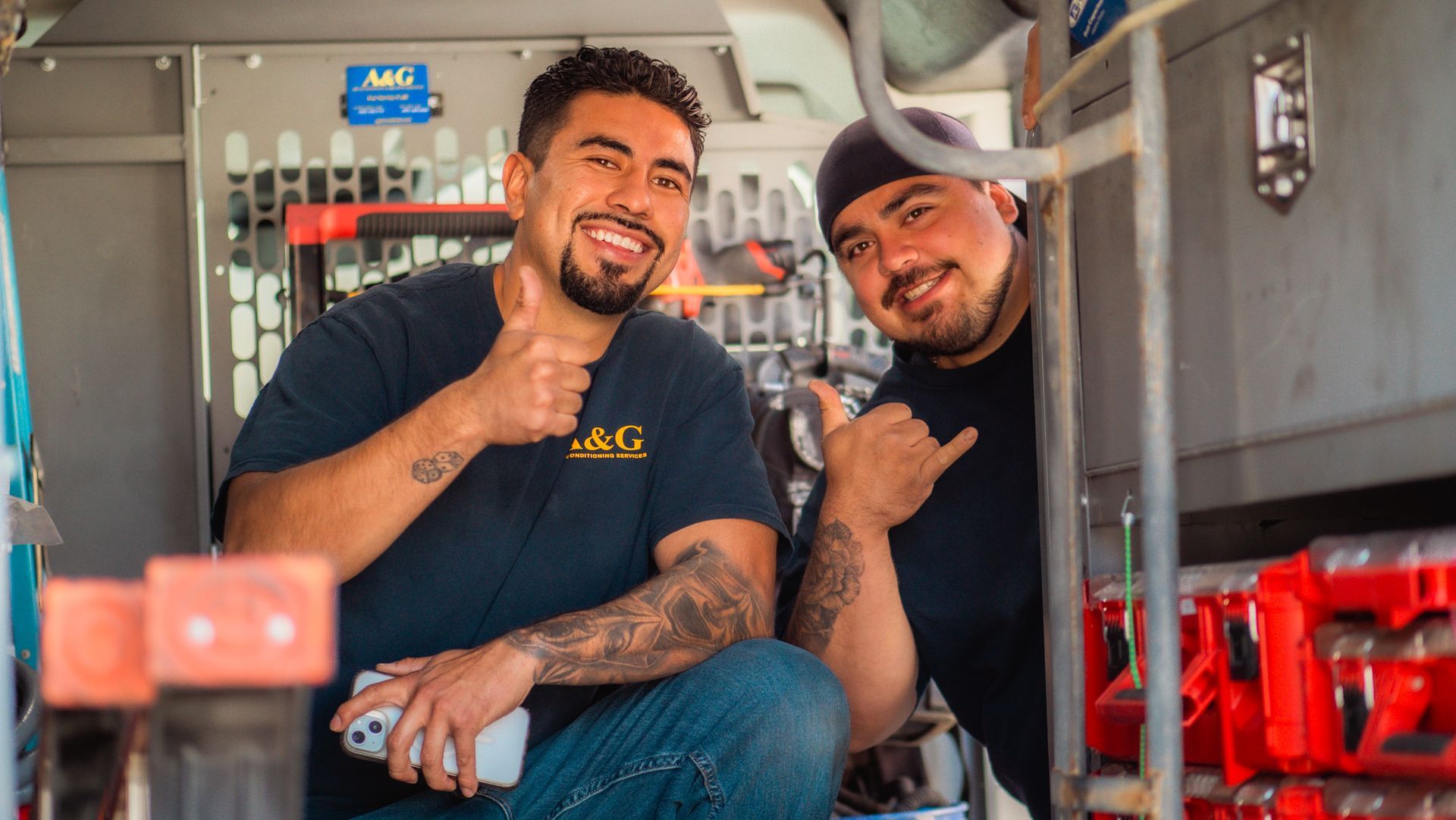 A & G Technician are sitting in a van and giving a thumbs up in San Bernardino County