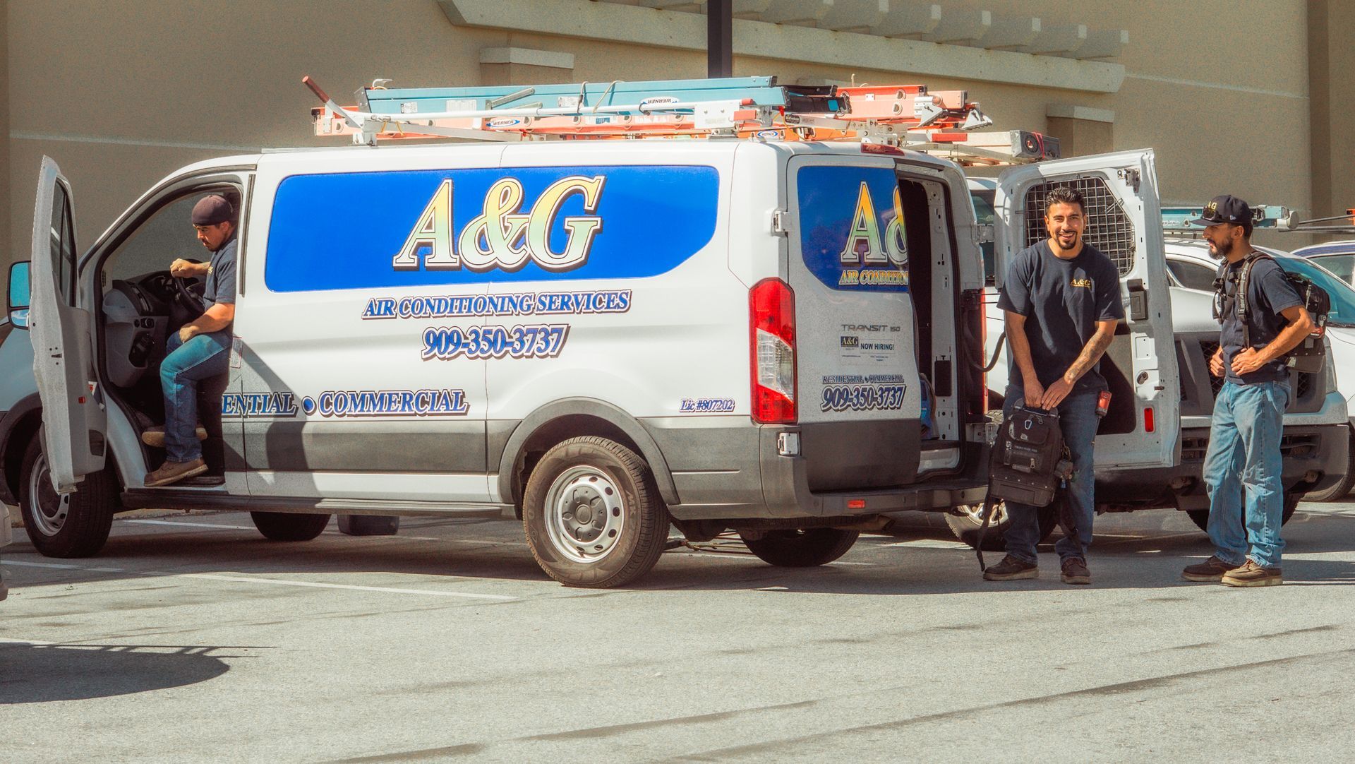 A group of A & G Technician are standing next to a van.