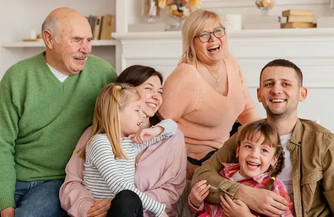 a family is posing for a picture together while sitting on the floor