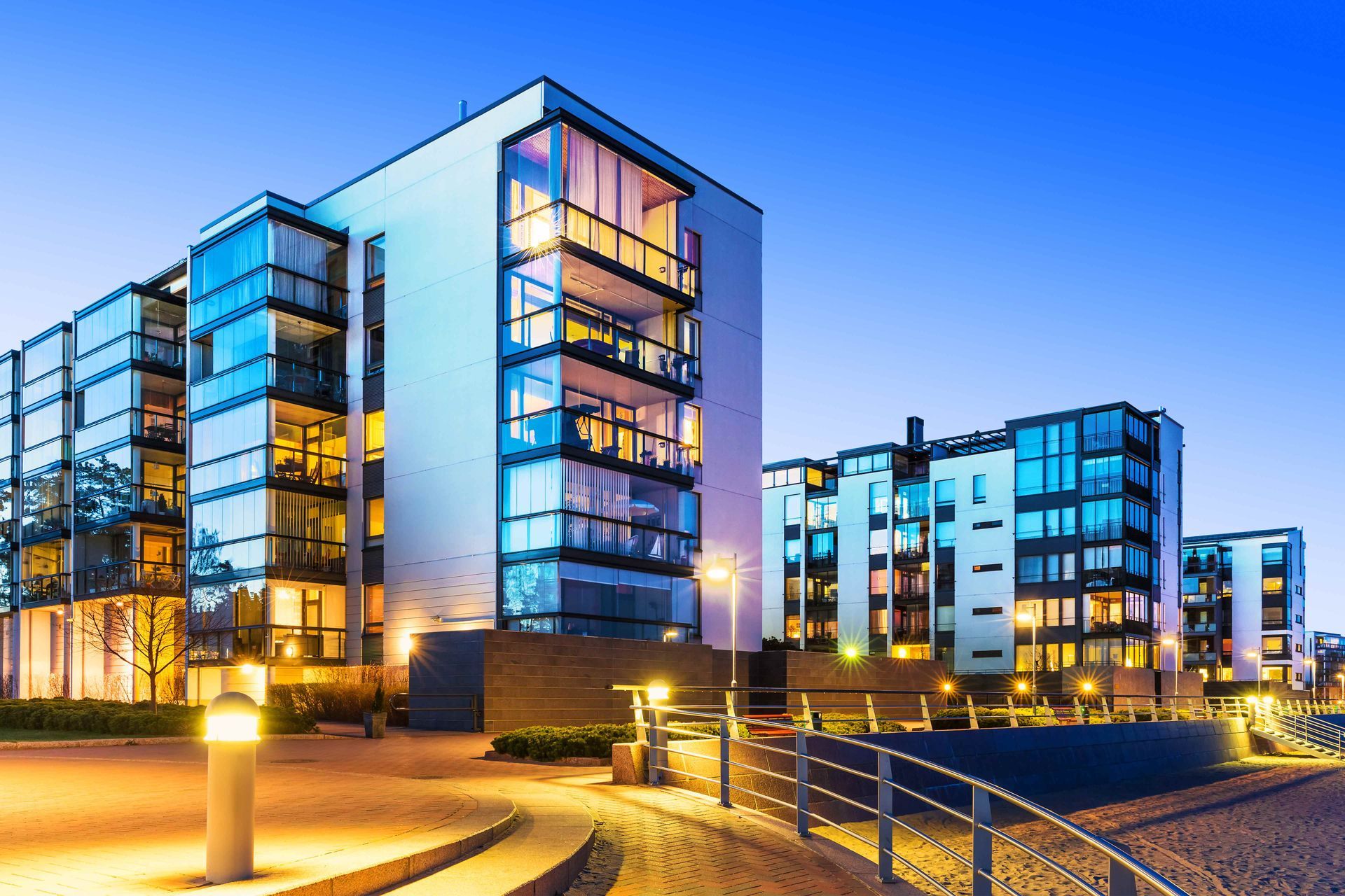 a large apartment building with a lot of windows is lit up at night