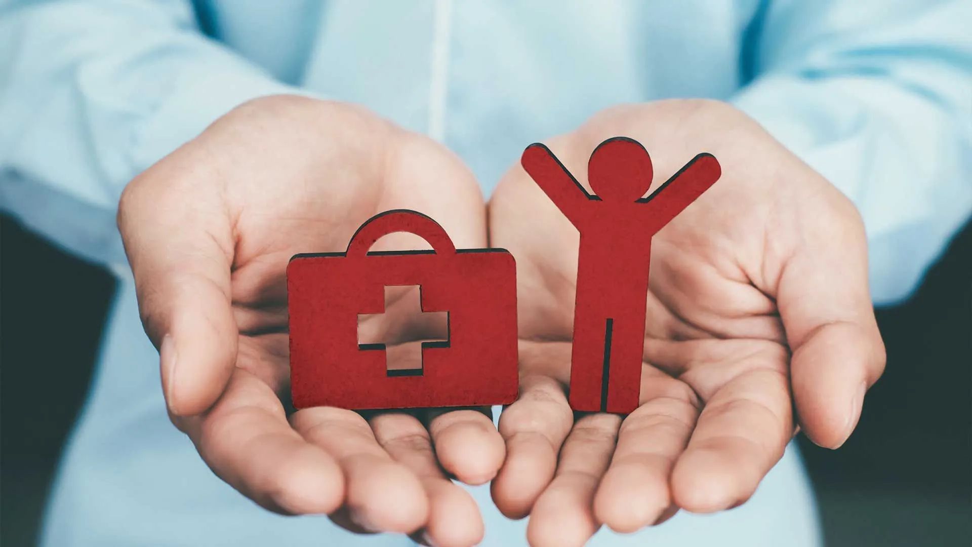 a person is holding a first aid kit and a person in their hands