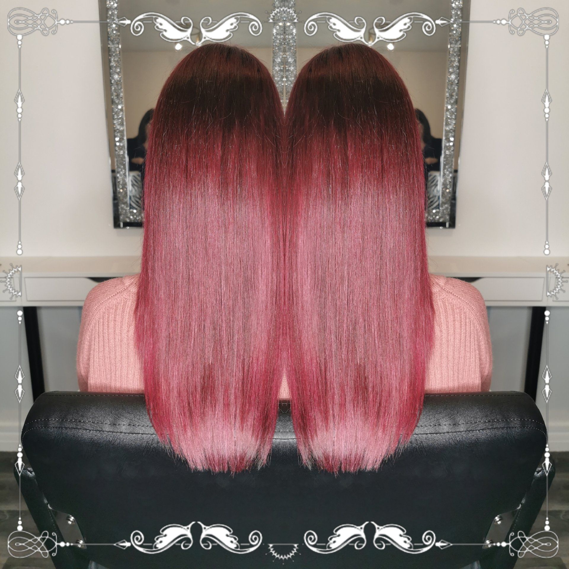 A woman with long pink hair is sitting in a chair