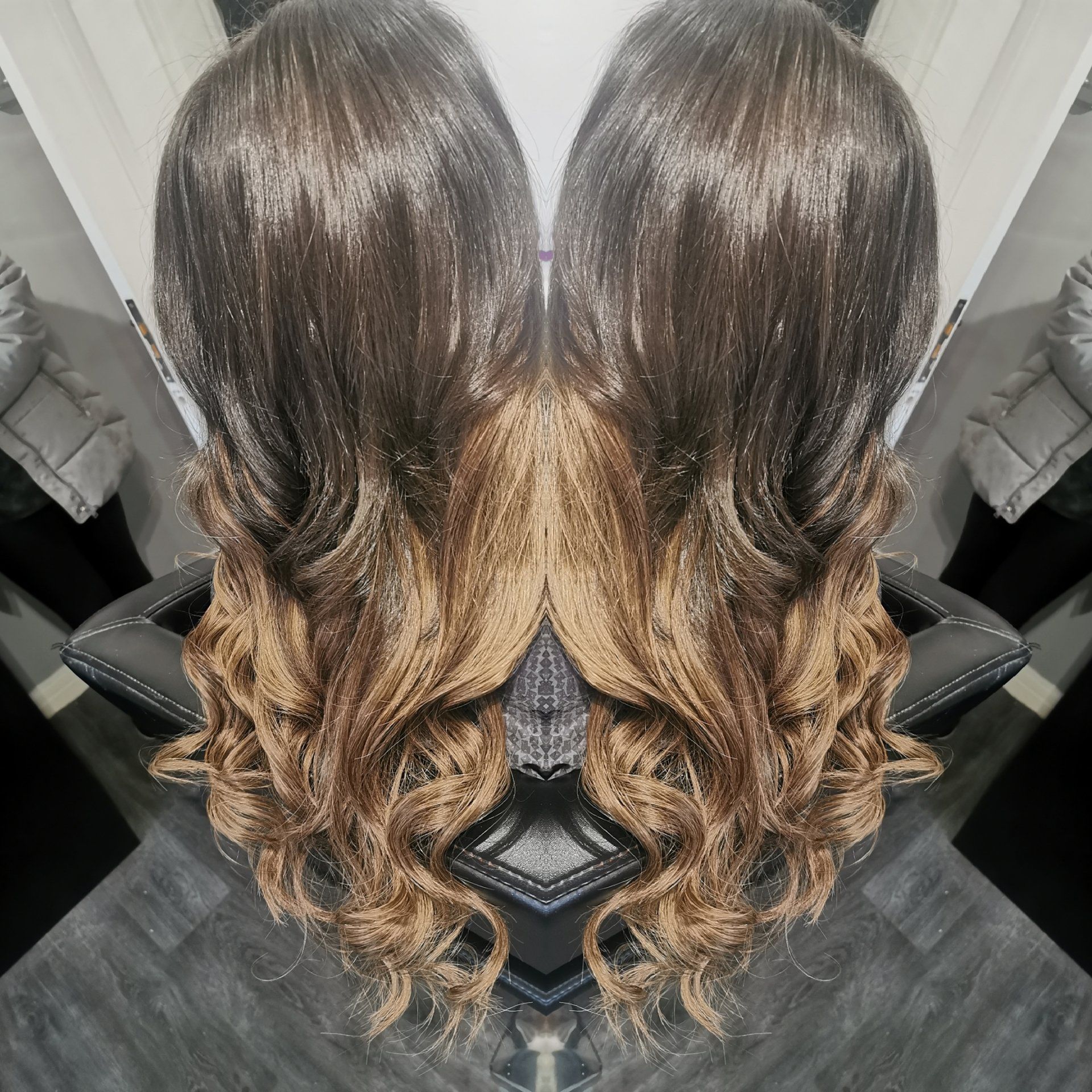 A reflection of a woman 's hair in a mirror