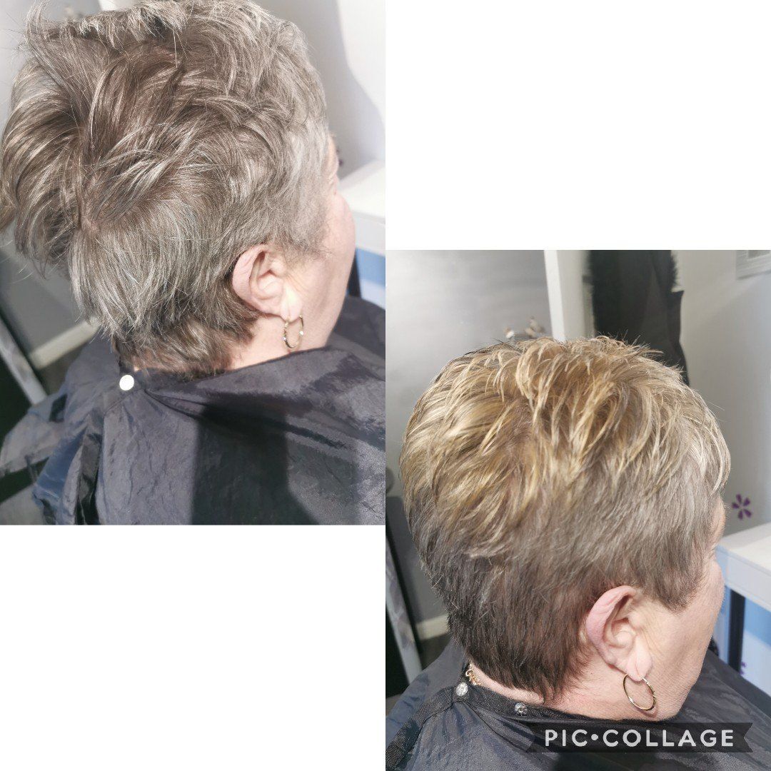 A woman is getting her hair cut in a salon.