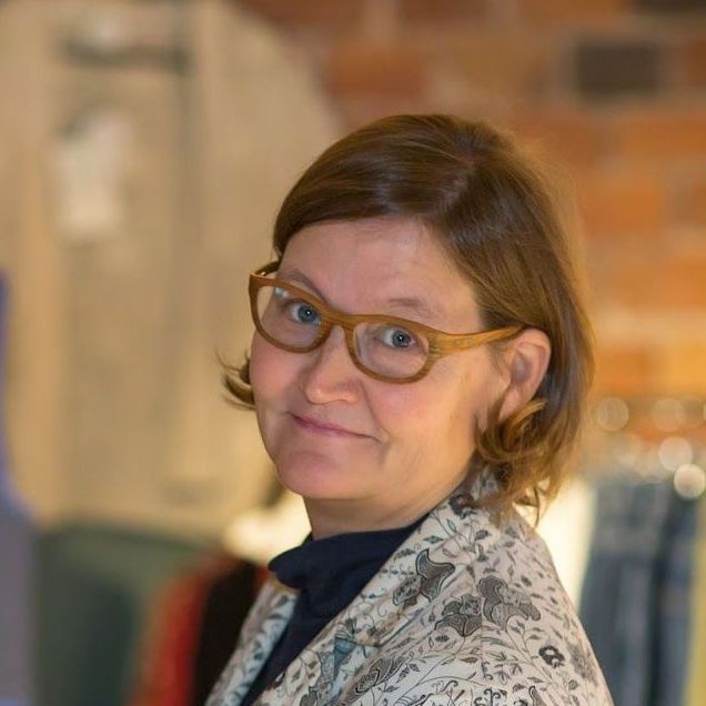 Sanna Leino from fair.fi wearing glasses is smiling for the camera