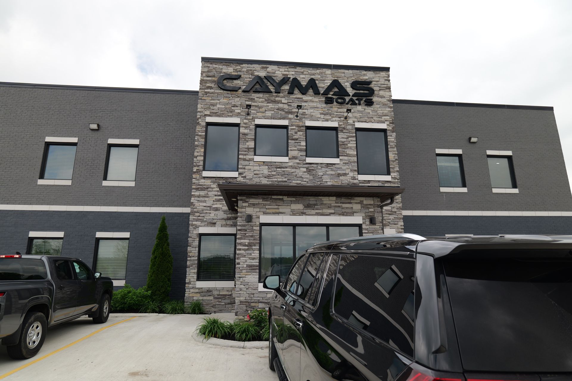 Cars are parked in front of a building that says cayman