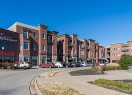A large brick building with cars parked in front of it.
