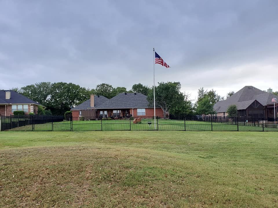 An american flag is flying in front of a house