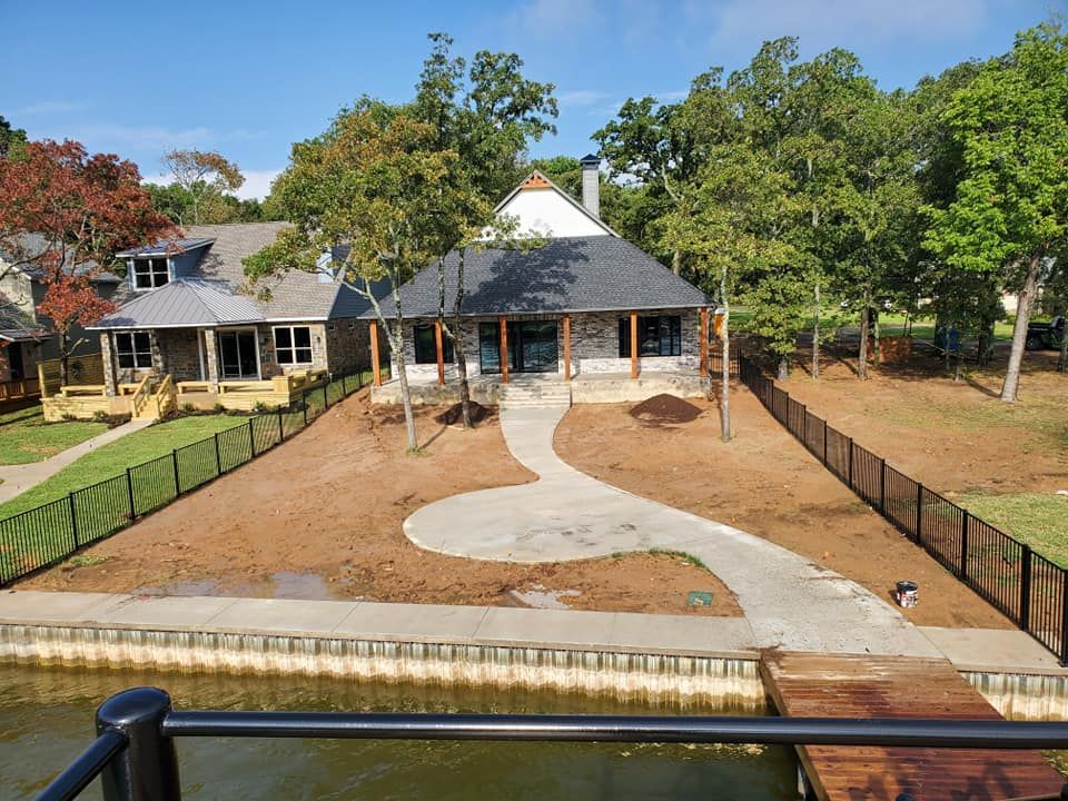 A house with a fence around it and a walkway leading to it