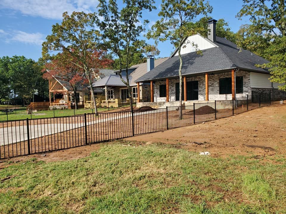 A house with a fence in front of it is being built.
