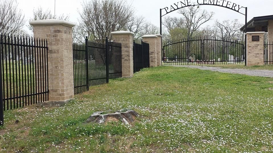 A cemetery with a fence and a sign that says payne cemetery