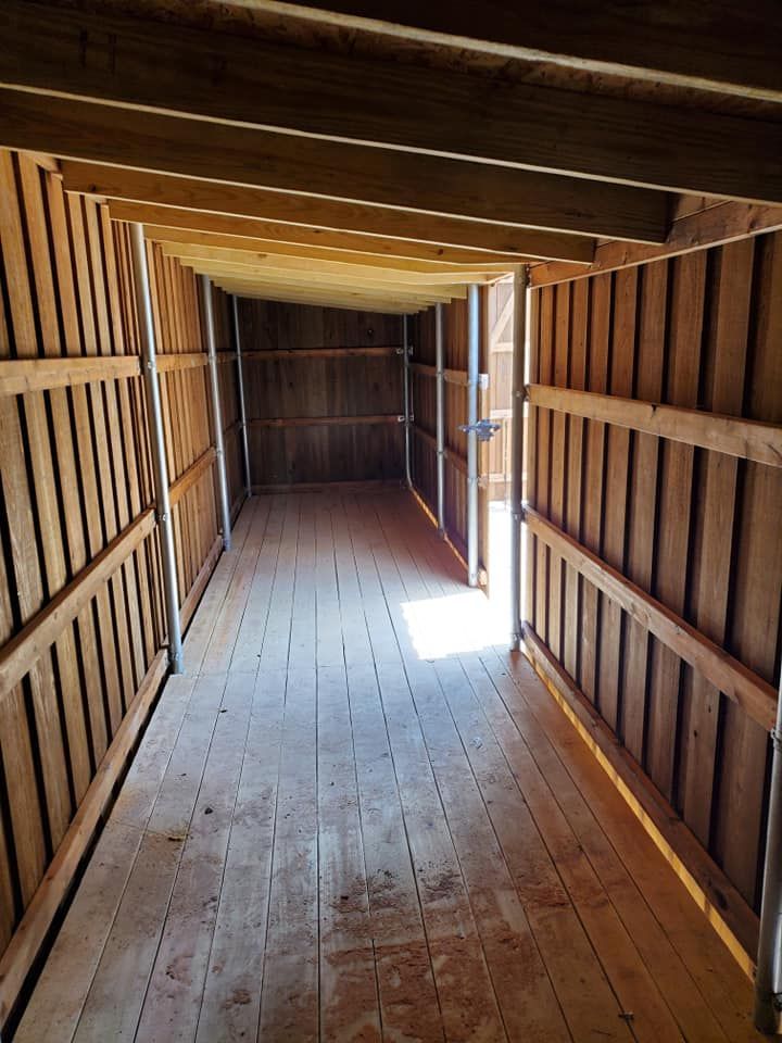A long wooden hallway with a wooden floor and walls