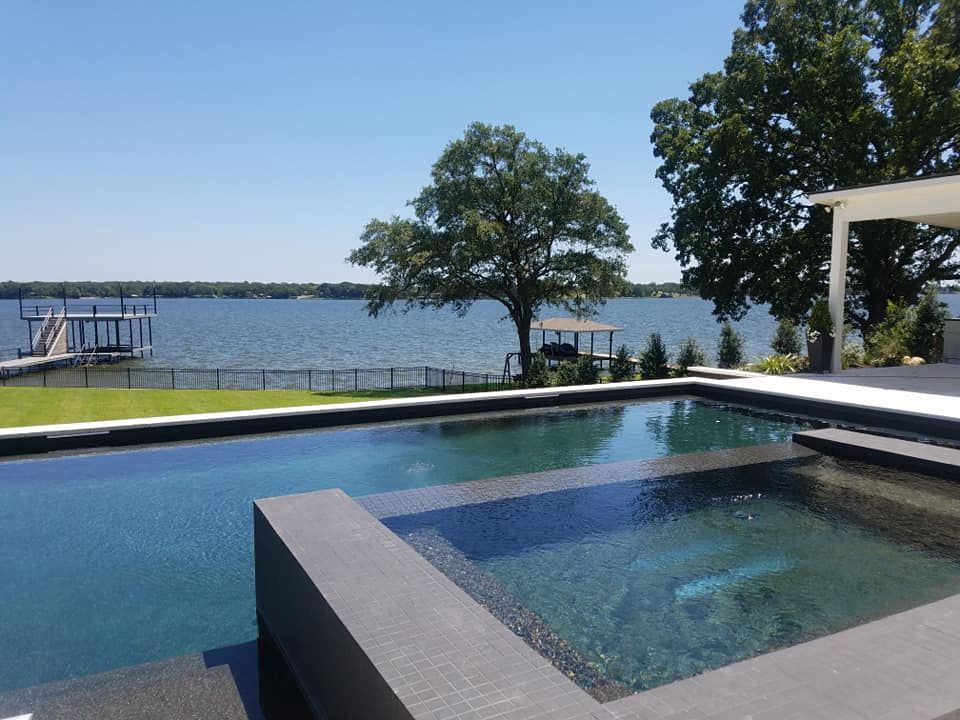A large swimming pool with a view of a lake