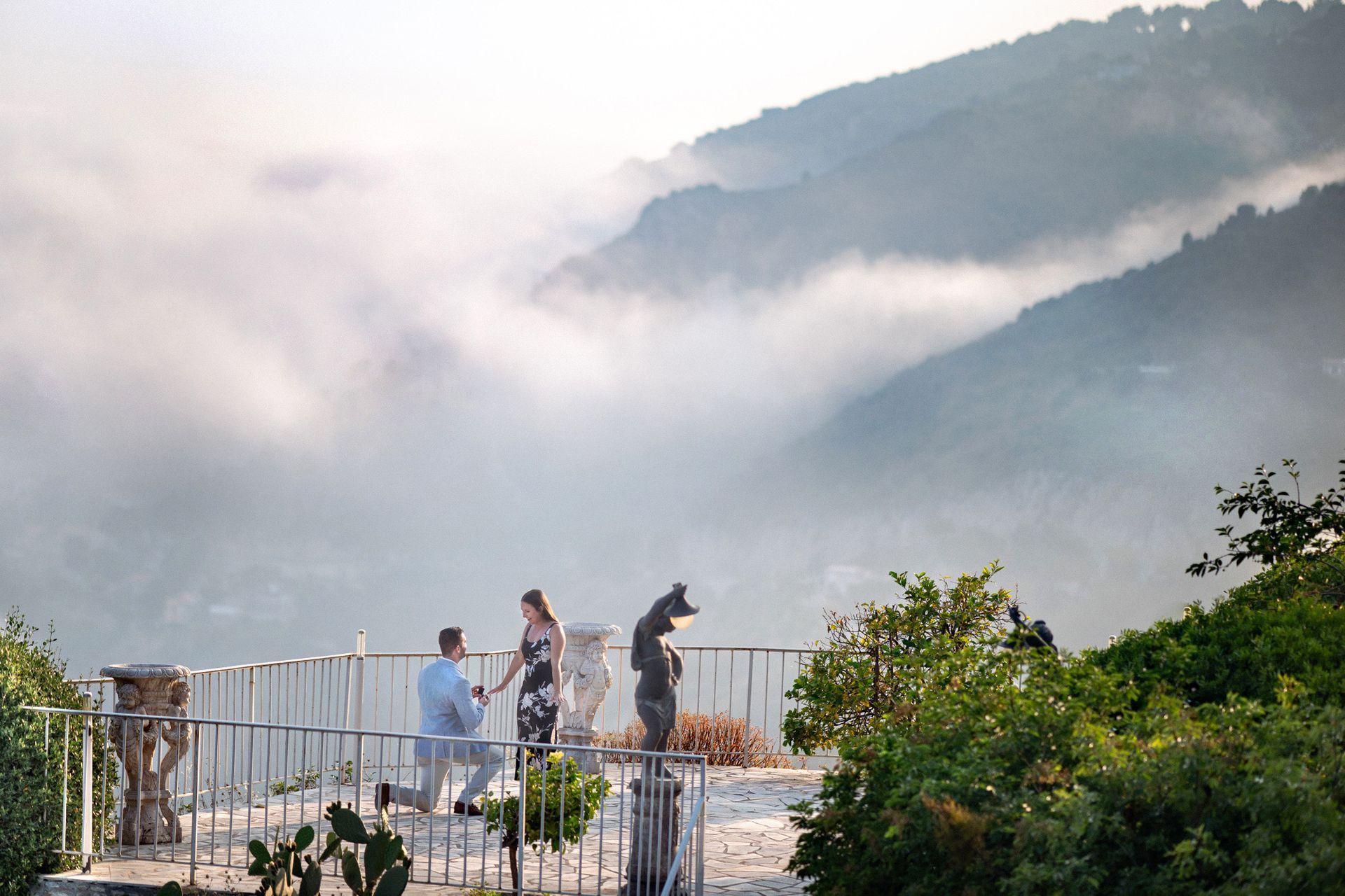 An engagement photograph with a stunning view taken from the Chevre d'Or hotel in Eze, France