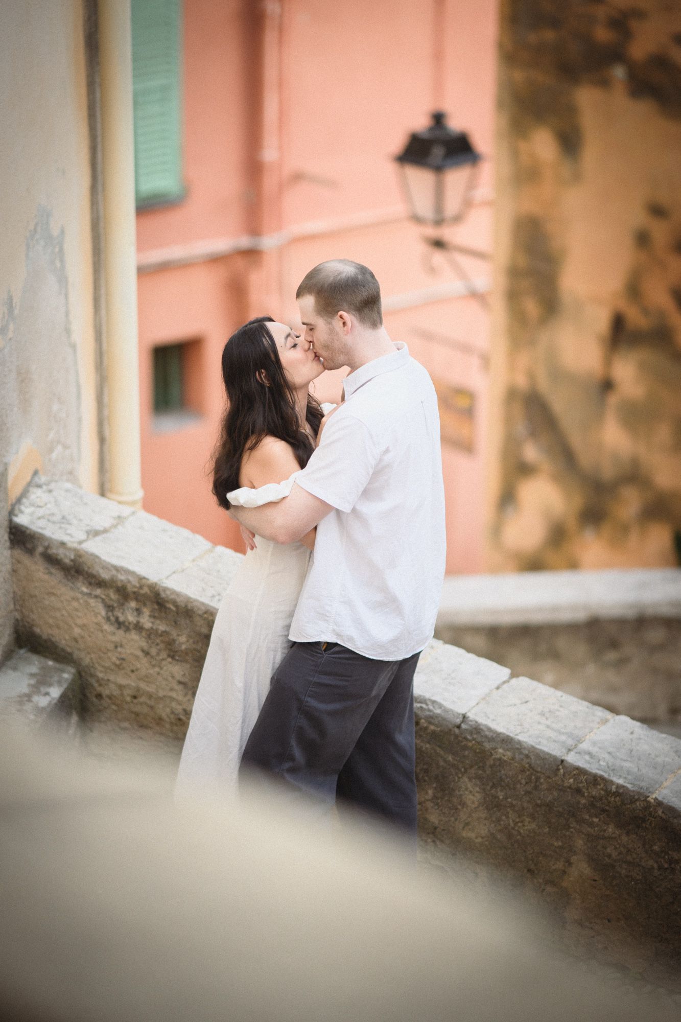 A couple kissing during a photoshoot in Menton