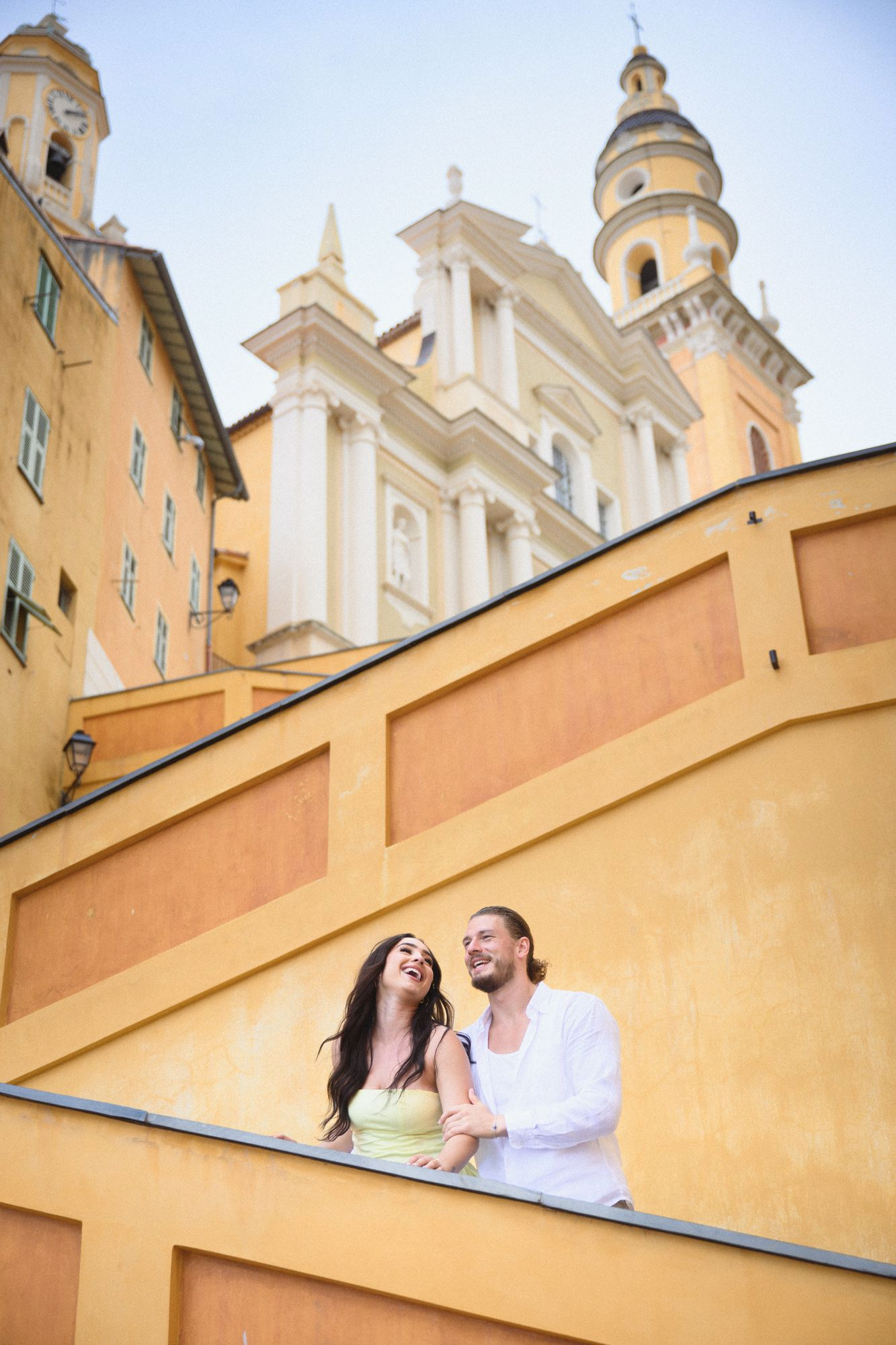 A couple portrait on Menton's yellow staircase, les Rampes de Saint-Michel