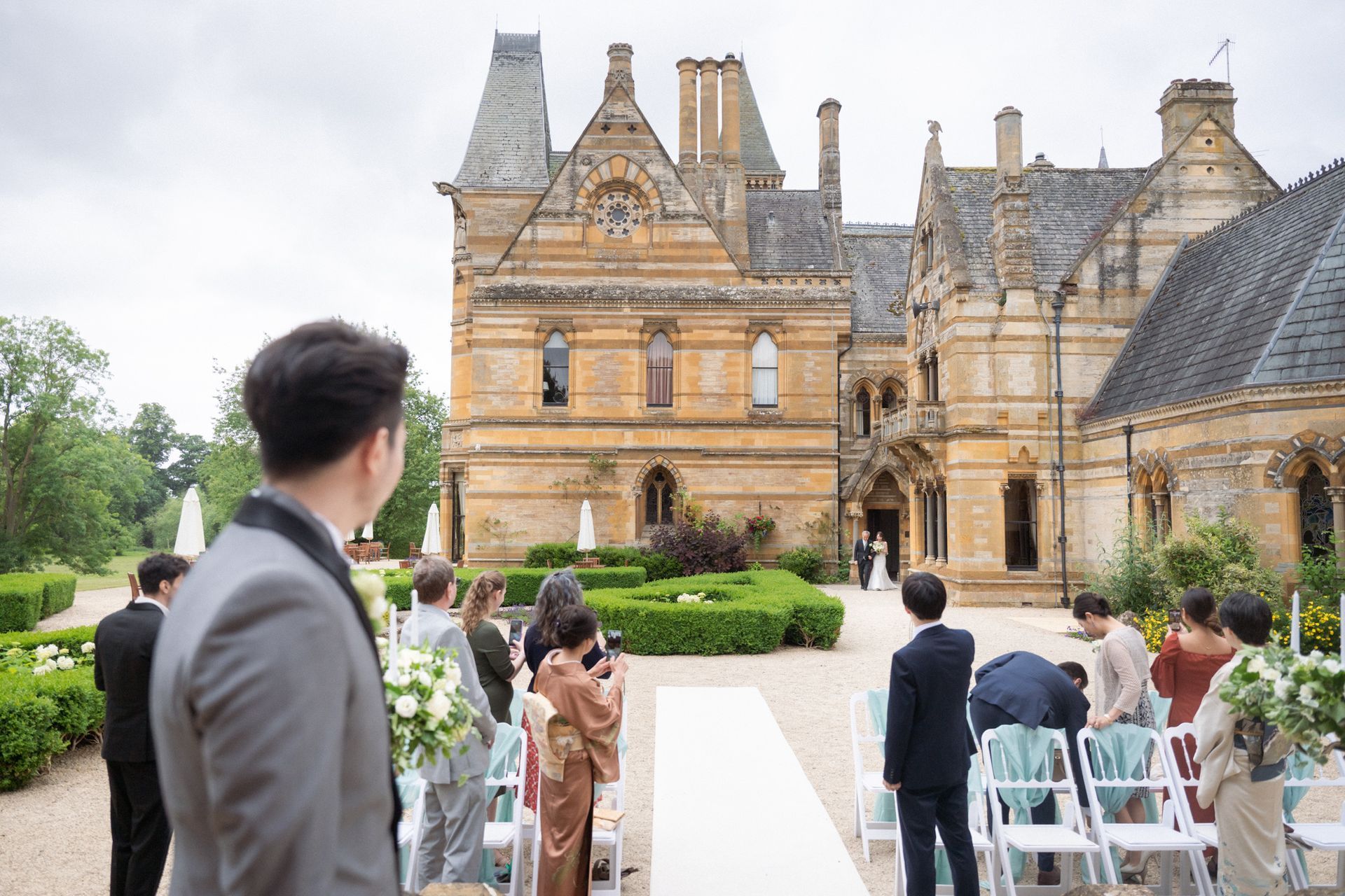 The groom at an outdoor wedding ceremony at Ettington Park