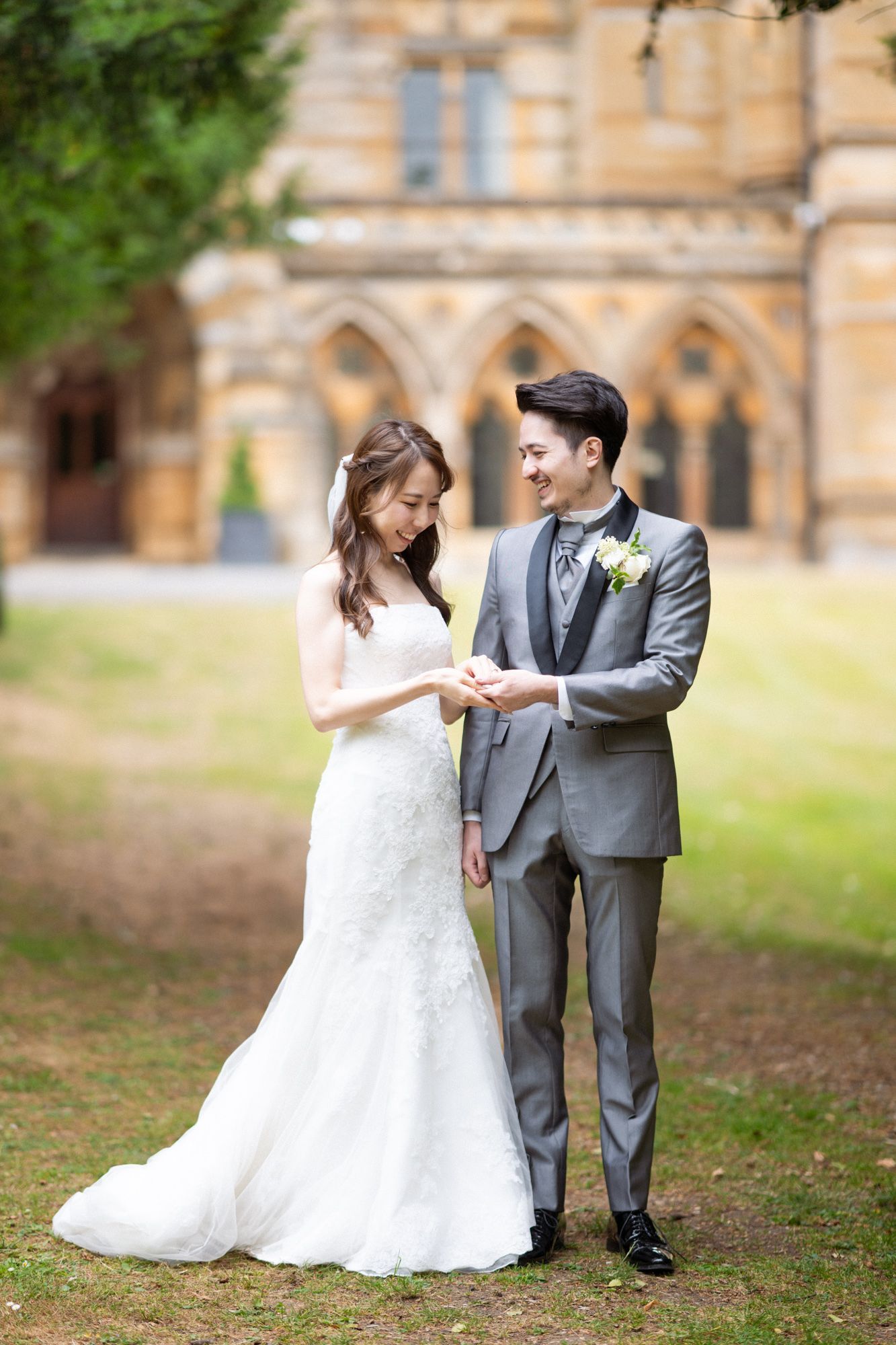 Newlyweds laugh and smile during a relaxed, natural photoshoot at Ettington Park