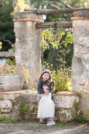 Two girls pose during a family photoshoot in Nice, France.
