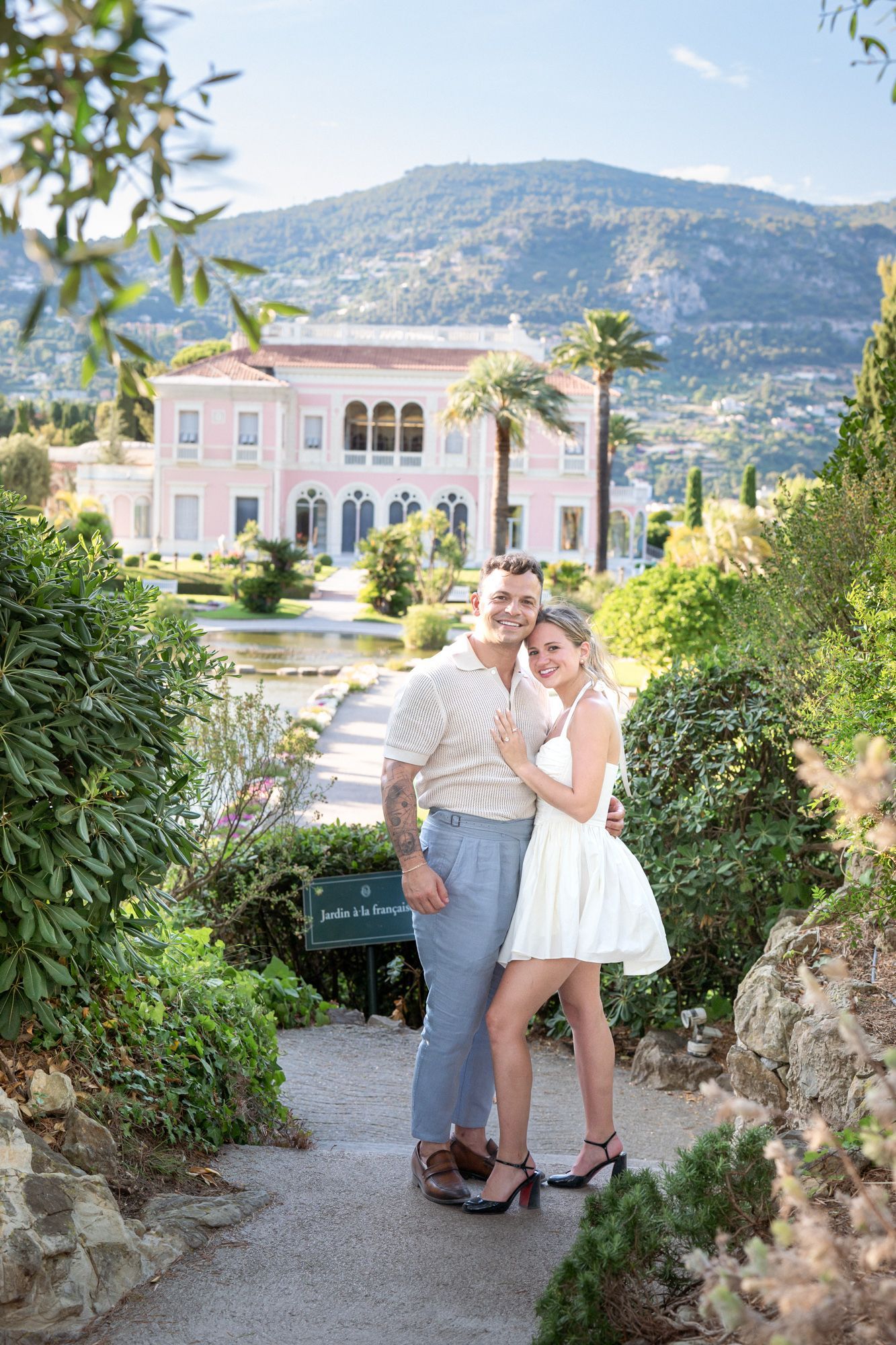 A couple pose before Villa Ephrussi on the French Riviera during a photoshoot.