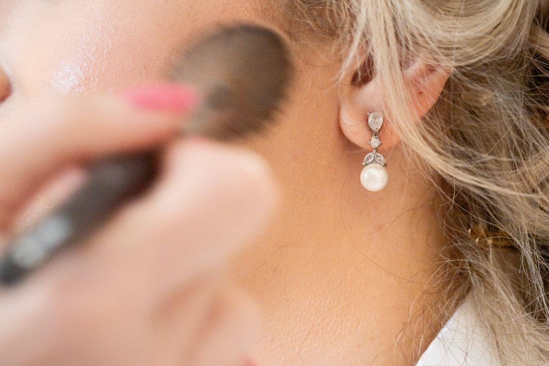 A close up photograph of bridal preparations - make up being applied.