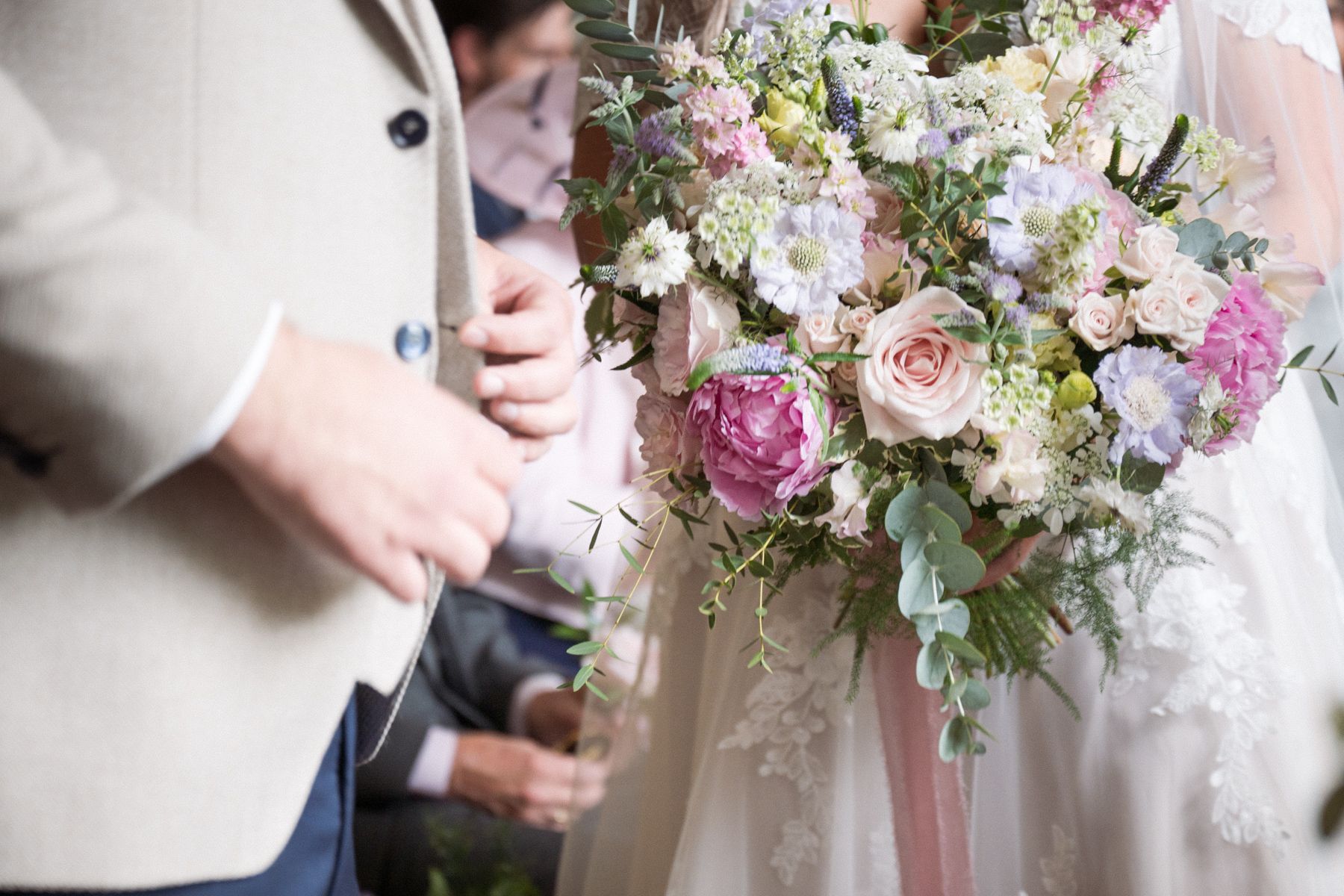 A big, colourful, bold bridal bouquet of flowers with mixed pink and lilac flowers.