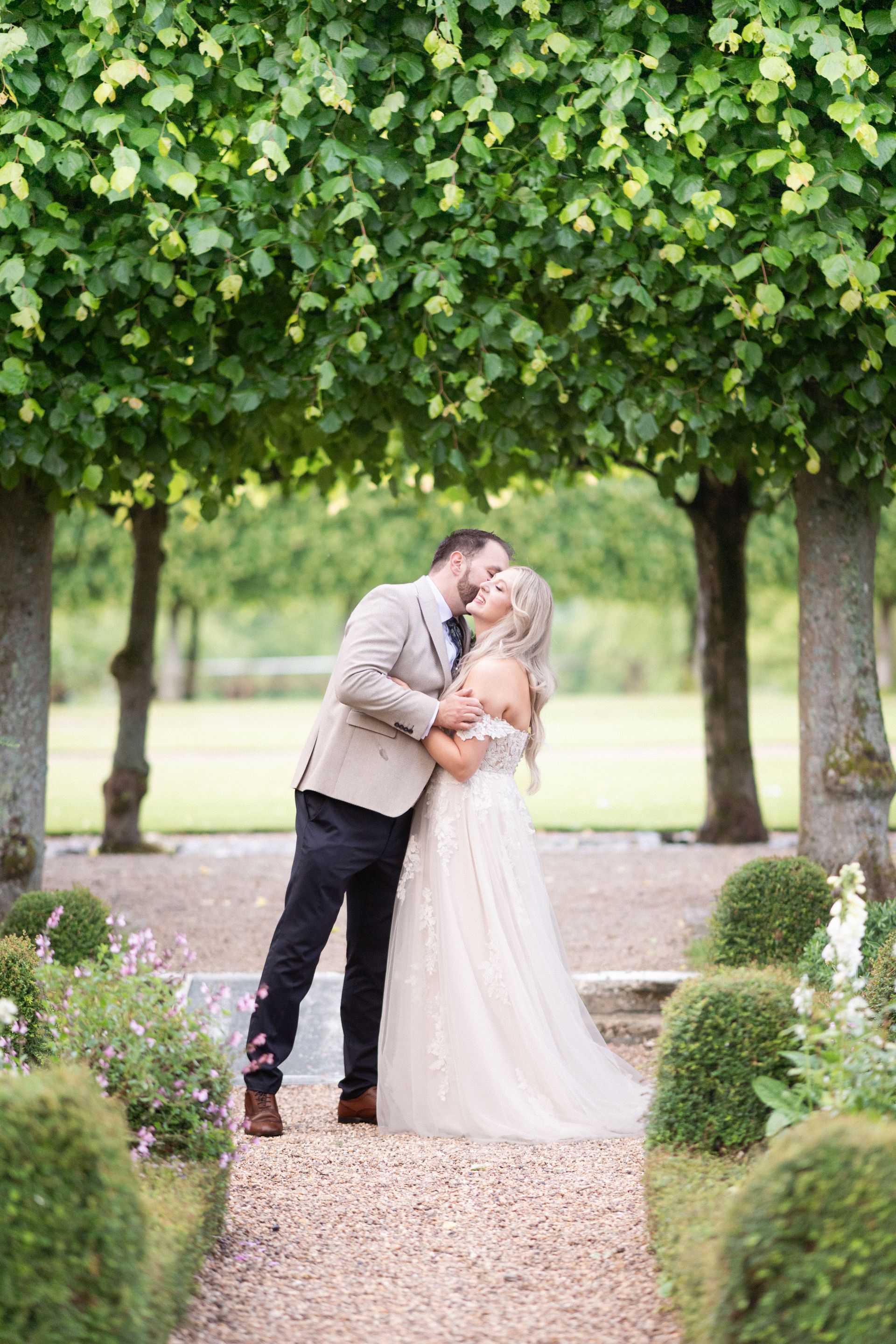 Newly weds have some portrait photos taken in the grounds of Kelmarsh Hall.