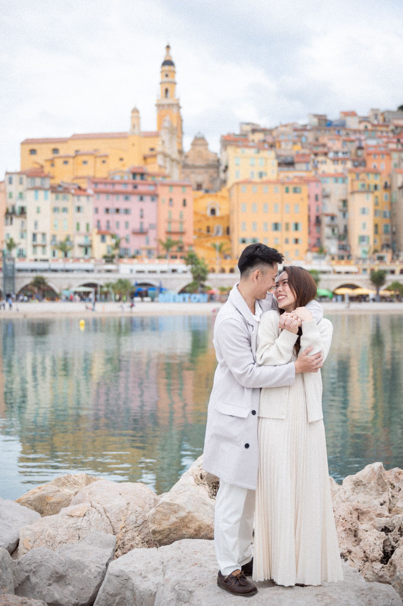 A couple laugh and joke during a candid-style photoshoot after their engagement on the French Riviera.