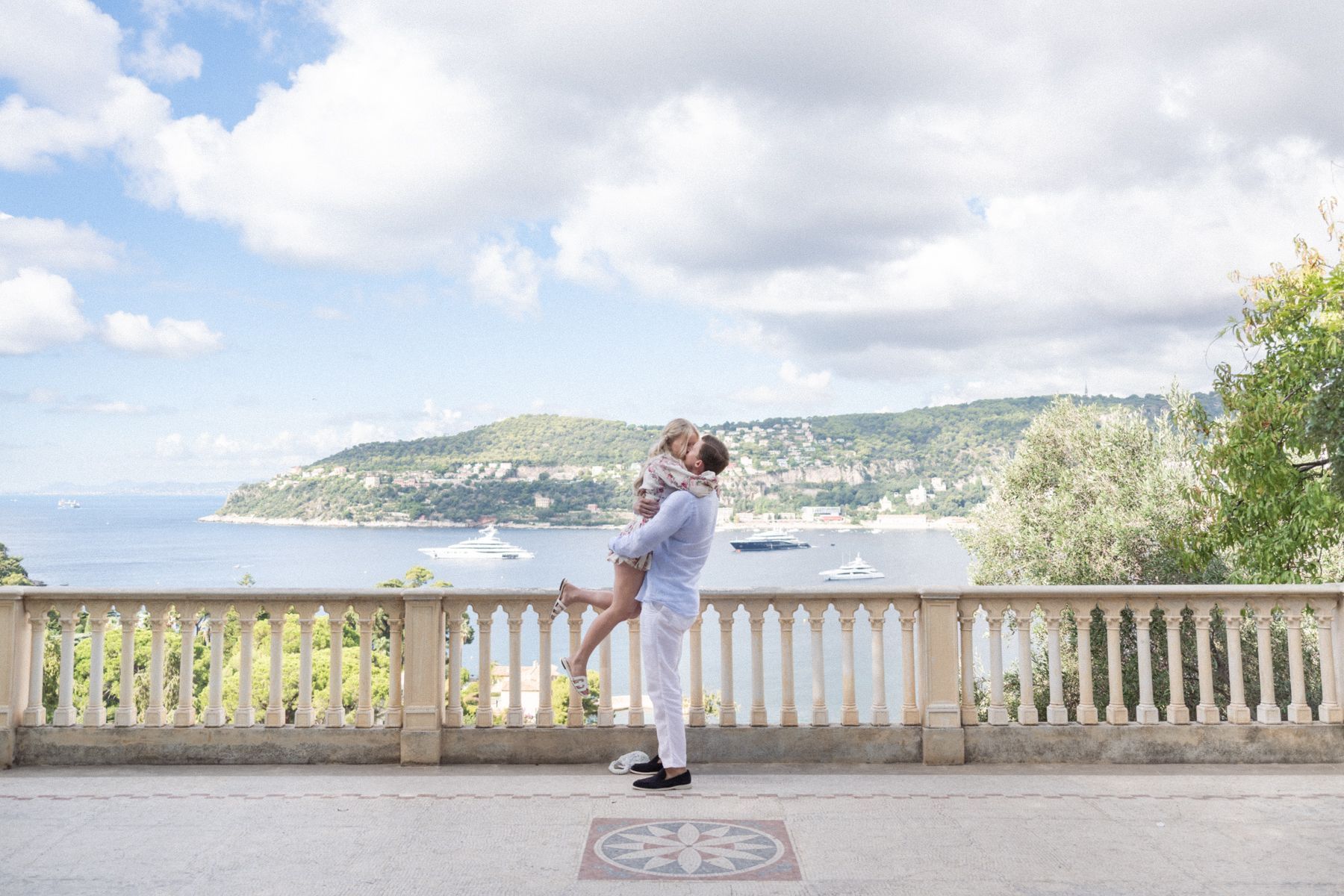 A woman jumps for joy after her proposal at Villa Ephrussi.