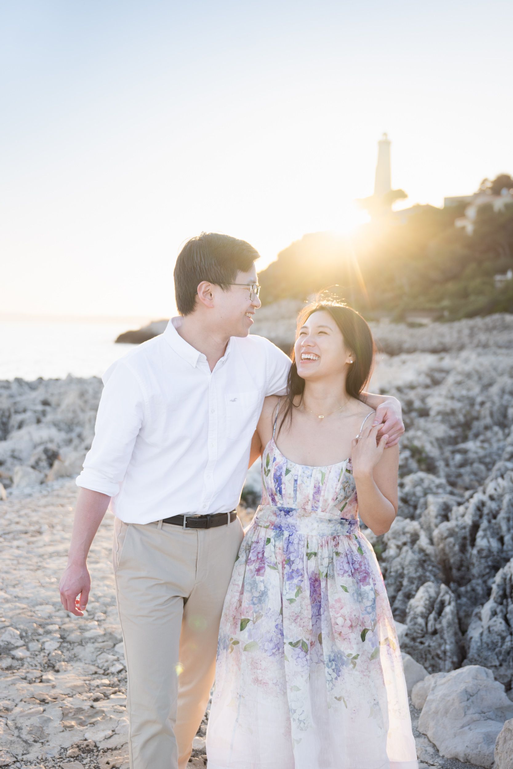 A professional photograph of a young couple during a romantic photoshoot at sunset on the French Riviera.