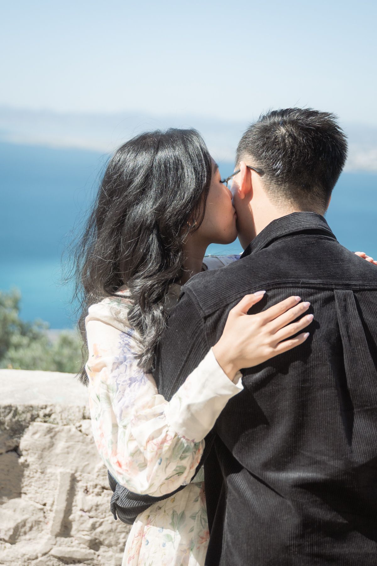 A couple embrace after getting engaged.