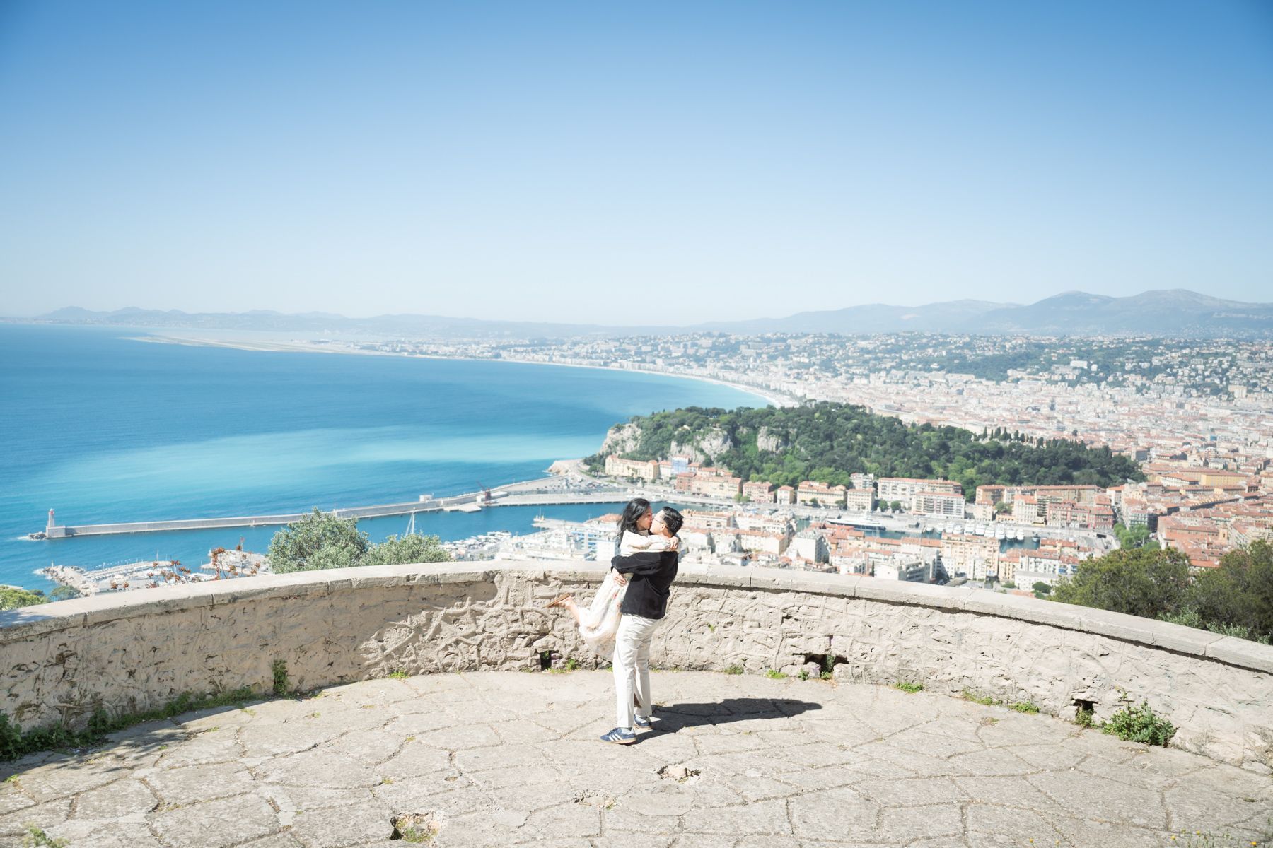 A woman jumps for joy after accepting a proposal in Nice, Framce