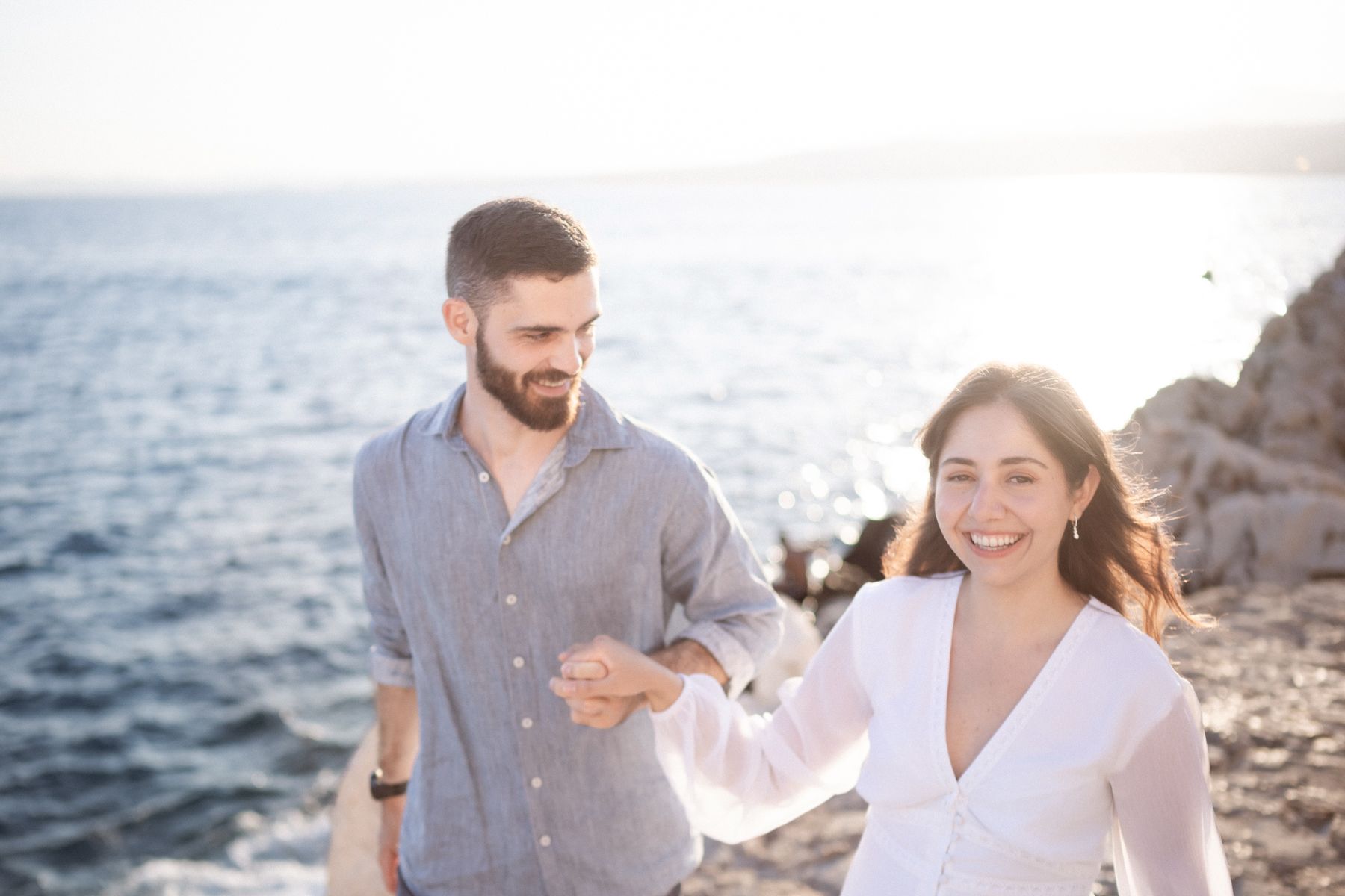 A couple laugh during an unposed romantic photography session in Nice, France.