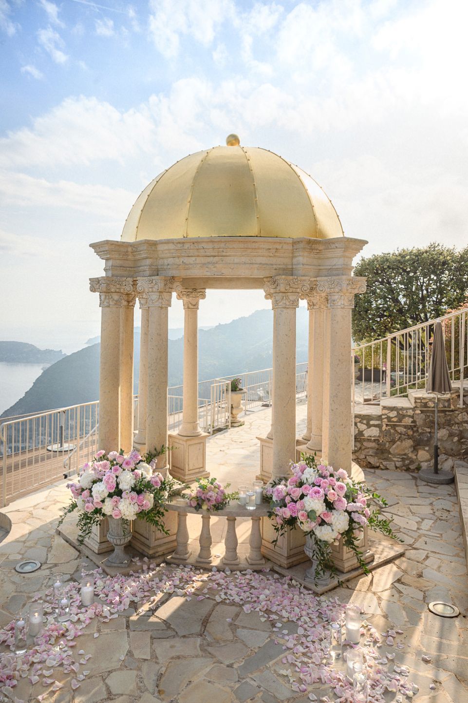 The Temple of Love in the terraces of the Chevre d'Or at sunset with flower and candle display.