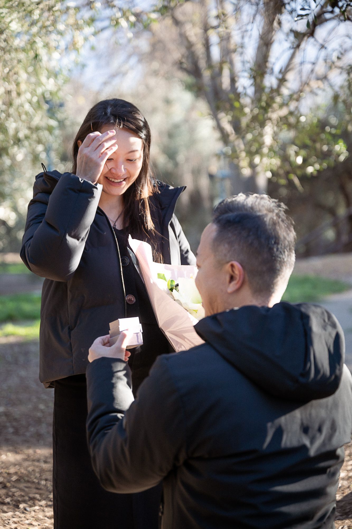 A woman reacts to her surprise proposal in winter on the French Riviera