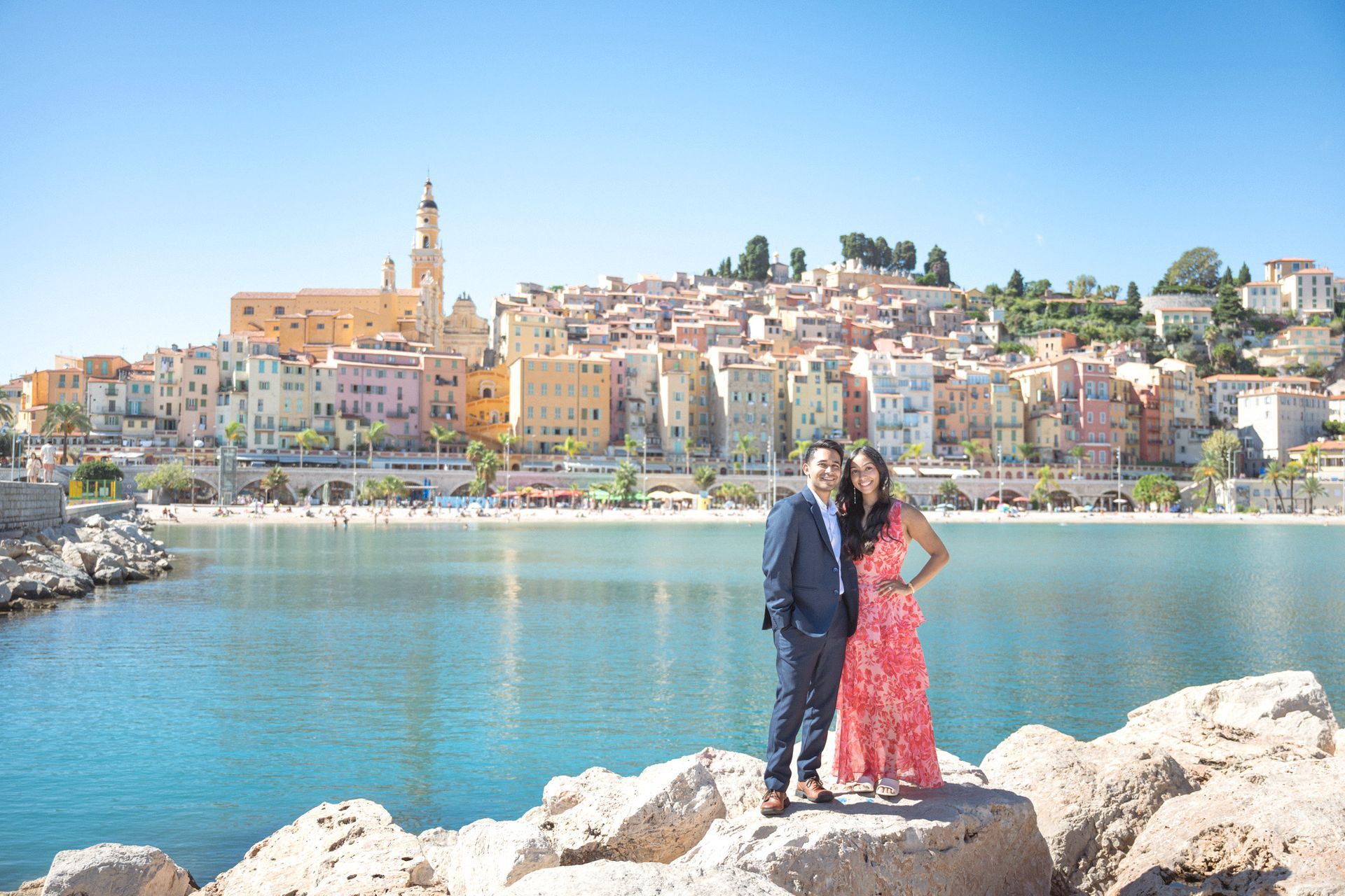 A couple portrait at Menton's Panoramic viewpoint with a view of the old town in the background.